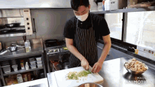 a man wearing a face mask is cutting vegetables on a cutting board made in animatica
