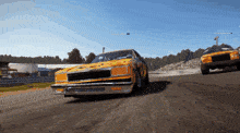 a yellow race car is driving down a track with another car