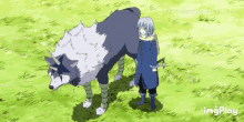 a person standing next to a large animal with a unicorn horn