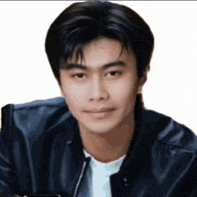 a young man wearing a black leather jacket and white shirt