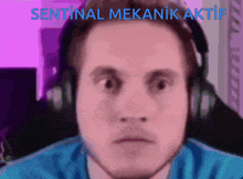 a man is wearing headphones and the words sentinal mekanik aktif are above his head