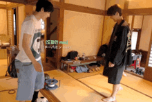 two men are standing next to each other in a room and one has the word max written on his shirt