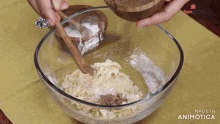 a bowl of food is being stirred with a wooden spoon and says made in animatica