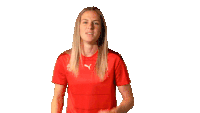a woman wearing a red puma shirt is dancing