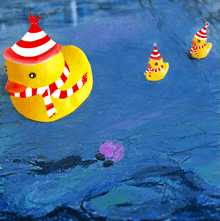 a yellow rubber duck with a red and white hat and scarf