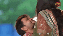 a man is smiling in front of a dangal tv banner