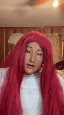 a woman wearing a mask and red hair is wearing a white shirt that says ' duck ' on it
