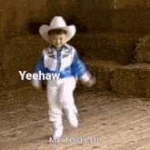 a little boy in a cowboy hat and boots is dancing in a barn .