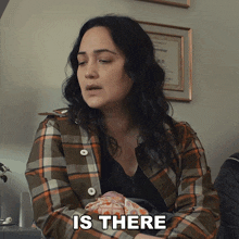 a woman in a plaid shirt is asking if there is anything