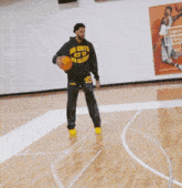 two men playing basketball in front of a poster that says " lakers " on it