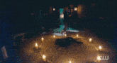 a close up of a person 's face with a candle in the background