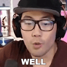 a man wearing glasses and headphones says well in a close up of his face