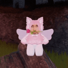 a man in a pink cat costume is holding a pink rose in his mouth .