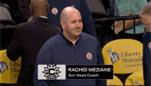 a man named rachid mezianie sits in the stands