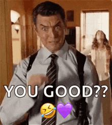 a man in a suit and tie is pointing at the camera and says `` you good ? '' .