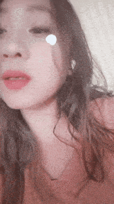 a close up of a woman 's face with a white circle on her face