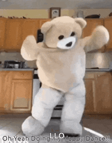 a teddy bear is dancing in a kitchen in a costume .