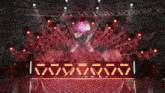 a stage with red lights and a sign that says ' vavavava ' on it