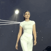 a woman wearing a white t-shirt that says perfume