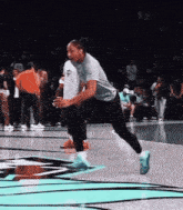 a woman is playing basketball on a court with a crowd watching
