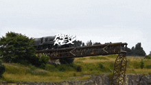 a train is going over a bridge with the words paper rex written on the bottom