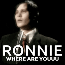 a man singing into a microphone with the words ronnie where are youuu