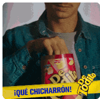 a man in a denim jacket is holding a can of de quito chips