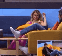 a woman is sitting on a yellow couch with her feet on a table