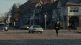 a man in a suit is crossing the street in front of a building that says ' abercrombie & fitch '