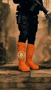 a person wearing a pair of orange boots with a bitcoin coin on them