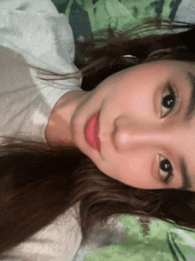 a close up of a girl 's face with a white shirt on