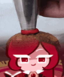 a cartoon character with red hair is being decorated with frosting and a hat .