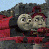 two thomas the train characters are sitting next to each other .