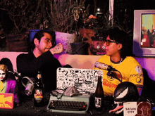 a man wearing a yellow shirt that says ' satan city ' on it