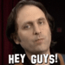 a man is making a funny face and saying hey guys