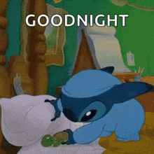 a cartoon character is sleeping in a bed with a turtle and the words `` goodnight '' .