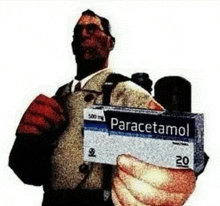 a man is holding a box of paracetamol in his hands