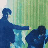 a man in a blue jacket is standing next to another man in a black jacket
