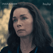 a close up of a woman 's face with the words paradise on the bottom