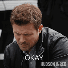 a man in a black jacket says okay hudson and rex