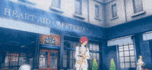 a man in a white suit stands in front of a building that says heart aid cafeteria