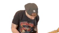 a man wearing a hard rock shirt plays a guitar