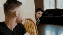 a man and a boy are sitting at a table .