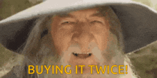 a man with a beard is wearing a hat and says " buying it twice "