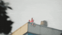 a blurred image of a person standing on the side of a building
