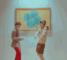 two people looking at a painting of a clover