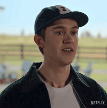 a young man wearing a hat and a jacket that says netflix on it