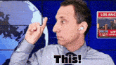 a man wearing ear buds and a tie says " this "