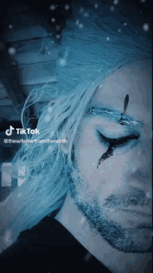 a close up of a man 's face with a tiktok sticker