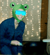 a woman wearing a green frog hat and blue goggles